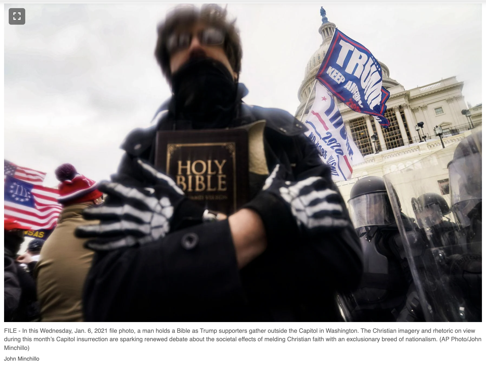 A protestor at the US Capitol holding a Christian Bible