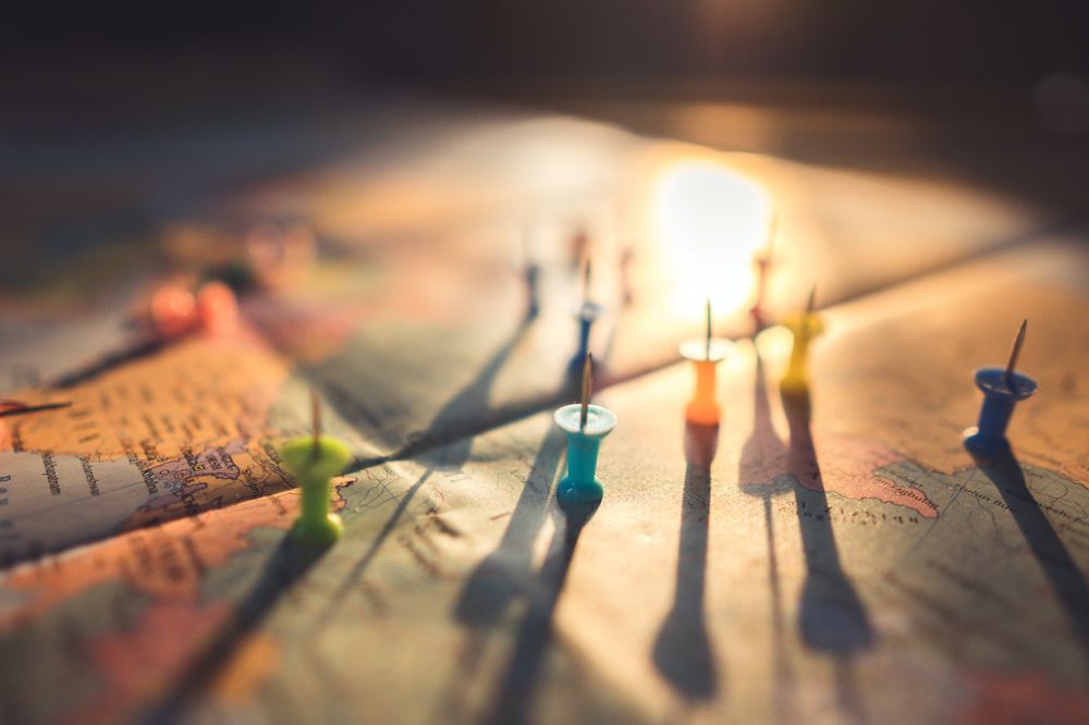 A world map with pins demonstrating boundary changes and urban growth.
