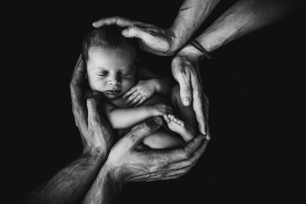 An unaborted baby safe between parent's hands.