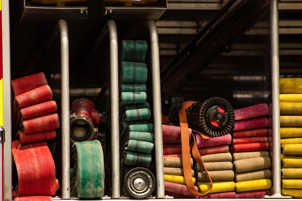 Multi-colored hoses on the side of a fire department truck.